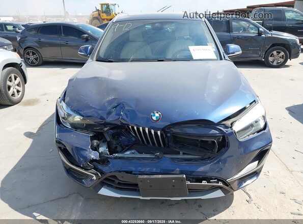 WBXJG7C0XM5U15715 2021 BMW X1 Blue Vista interior trasera