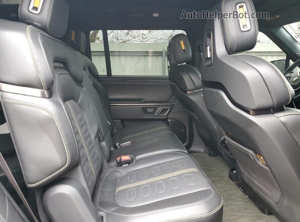 7PDSGABA4RN042504 2024 RIVIAN R1S Charcoal Rear interior view