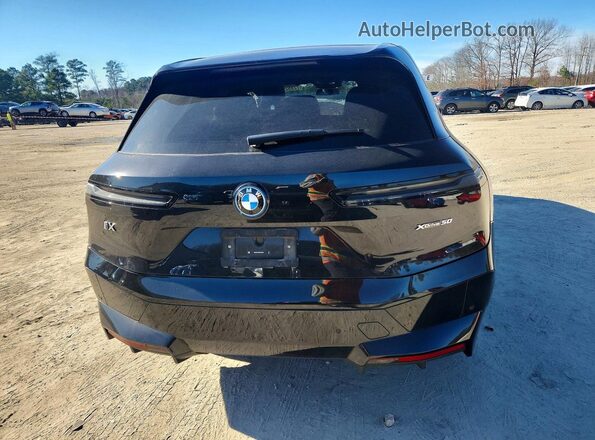 WB523CF00SCS31390 2025 BMW IX Black Vista trasera