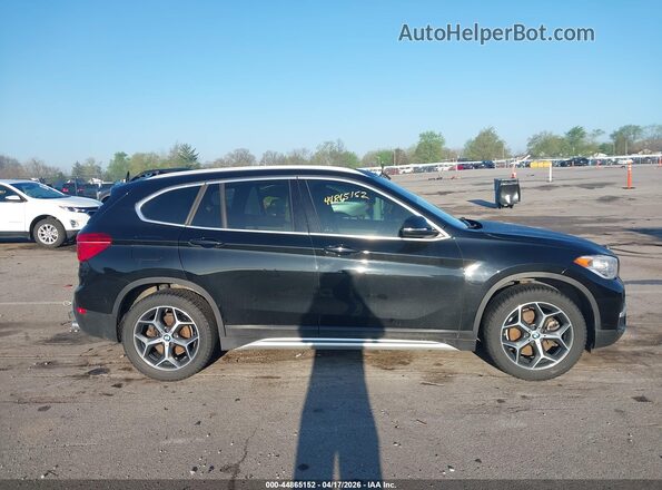 WBXHT3C5XK5L37562 2019 BMW X1 Black Rear interior view