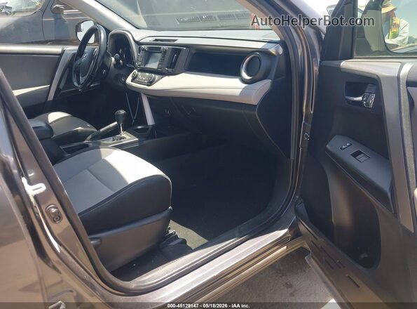 JTMWFREVXGJ073821 2016 TOYOTA RAV4 Gray წინა სალონის ხედი