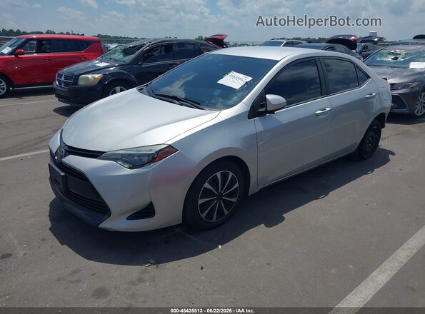 2T1BURHE3JC047922 2018 TOYOTA COROLLA Silver Vista tres cuartos delantera izquierda