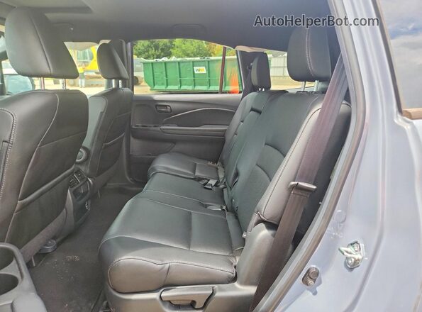 5FNYF8H56PB011631 2023 HONDA PASSPORT Blue Rear interior view
