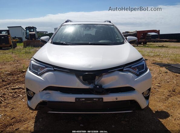 JTMDJREV5GD054548 2016 TOYOTA RAV4 HYBRID White Widok wnętrza z tyłu