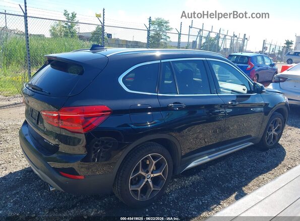 WBXHT3C34J5L30832 2018 BMW X1 Black Vista interior trasera