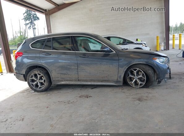 WBXHT3C35J5F89879 2018 BMW X1 Gray Vista interior trasera