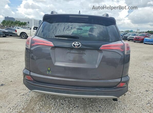 2T3NFREV7GW309712 2016 TOYOTA RAV4 Gray Vista trasera