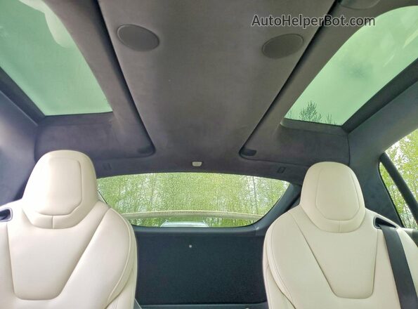 7SAXCBE51PF403490 2023 TESLA MODEL Cream Vista de los asientos traseros
