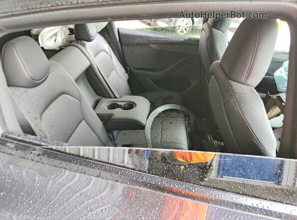 7SAYGDED2TF643475 2026 TESLA MODEL Charcoal Vista de los asientos traseros