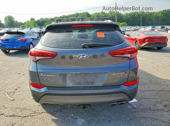 KM8J3CA2XGU074411 2016 HYUNDAI TUCSON Gray Rear view