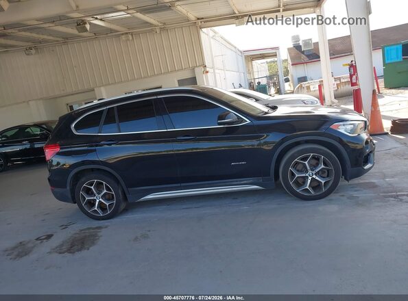WBXHT3C31G5F64289 2016 BMW X1 Black Սալոնի հետևի տեսք