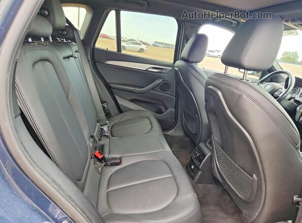 WBXHT3C39G5F63651 2016 BMW X1 Blue Vista interior trasera