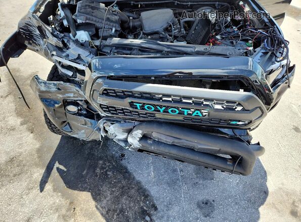 3TYAX5GN7PT082111 2023 TOYOTA TACOMA Black Սալոնի հետևի տեսք