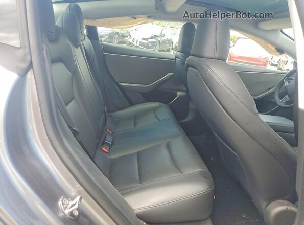 5YJ3E1EA0SF077834 2025 TESLA MODEL Gray უკანა სავარძლების ხედი