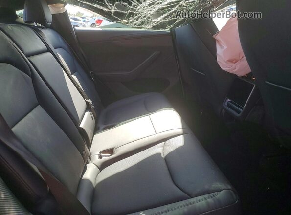 7SAYGDED1TA704277 2026 TESLA MODEL Charcoal Vista interior trasera