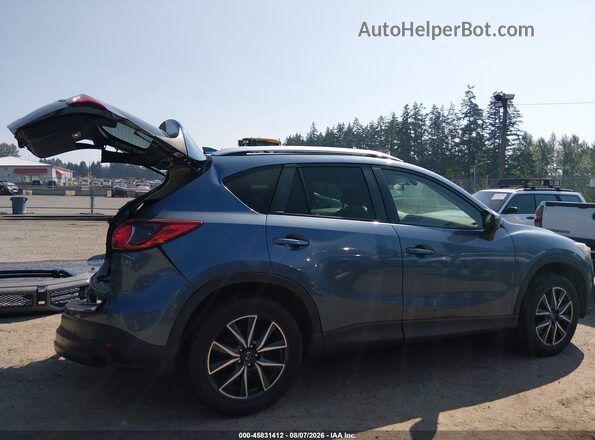 JM3KE4DY8G0762334 2016 MAZDA CX-5 Blue Vista interior trasera