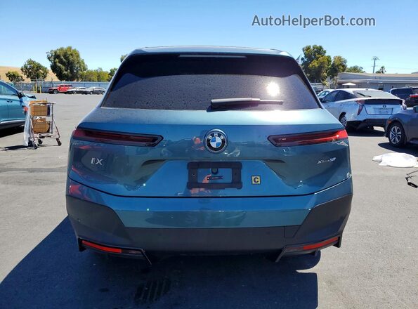 WB523CF07RCR74252 2024 BMW IX Teal Вид ззаду