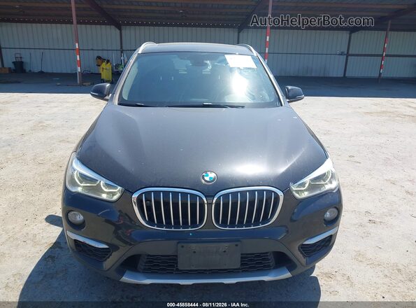 WBXHT3C32H5F68031 2017 BMW X1 Black Vista interior trasera
